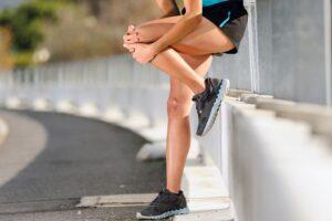 Woman Grabbing Her Knee In Pain