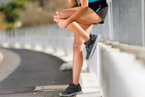 Woman Grabbing Her Knee In Pain